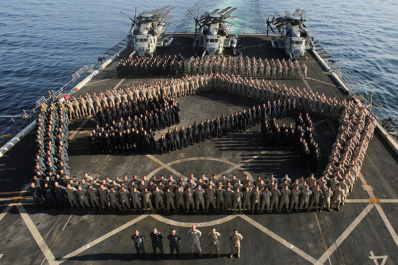 Sailors on the deck of an aircraft carrier